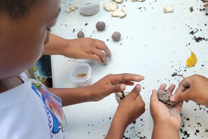 Children playing with clay on a white table
